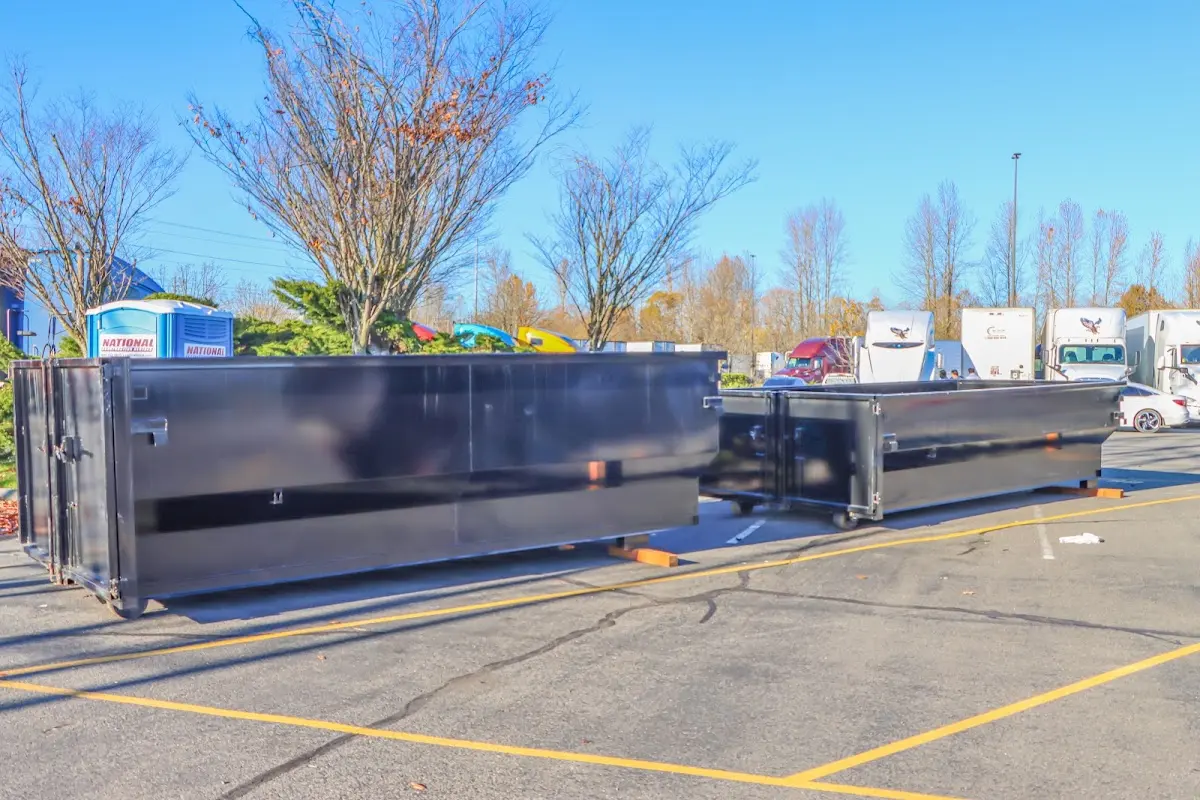 Professional dumpster rental service with roll-off container on residential driveway in Landover